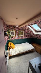 ベルファストにある3 bedroom house- East Belfastの壁紙のベッドルーム1室(ベッド1台付)