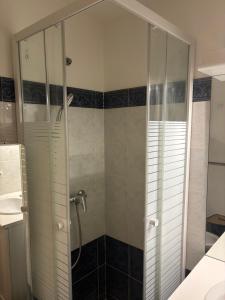a shower with a glass door in a bathroom at Studio Calif, face tram proche Mer in Nice