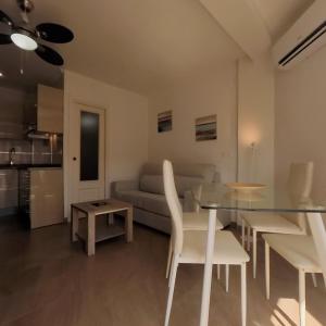 a living room with a table and a couch at Terrasol Estudios Plazamar in Torre del Mar +10 photos