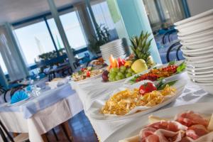 a table with three plates of food on it at Hotel Bellaria in Bellaria-Igea Marina