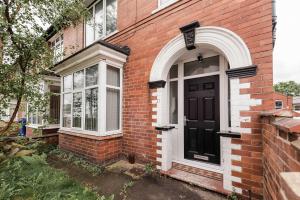 a brick house with a black door and windows at Peaceful Room in Doncaster Shared House w Kitchen in Doncaster