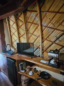 a room with a television on a wooden table at Hotel Boutique KaraKara in El Cuyo +16 photos