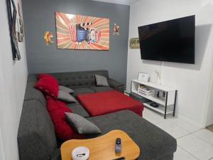 a living room with a couch and a flat screen tv at Baleares 2907 in Chihuahua