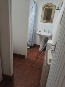a bathroom with a sink and a mirror and a toilet at Happy Homes in Plouyé