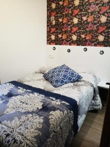 a bed with a quilt and a pillow on it at hospederia rincon de leon in León +22 photos