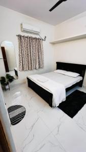 a white bedroom with a bed and a window at Boutique Bungalow 458 in Secunderabad +11 photos