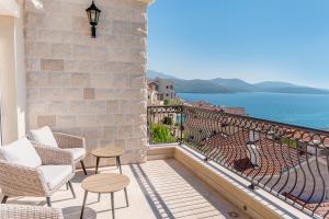 a balcony with chairs and a view of the ocean at Three Bedroom Family Apartment - Lustica Marina Village in Radovići