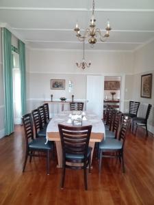 a dining room with a table and chairs at Twin Palms Accommodations in Mossel Bay