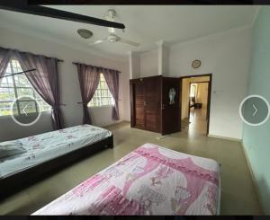 a large bedroom with a bed and a dresser at Villa Zara in Zanzibar City