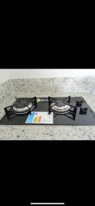 a gas stove top with a book on top of it at Bastos e Silva in Caldas Novas