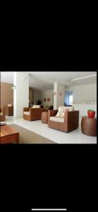 a living room with two brown couches and a table at Bastos e Silva in Caldas Novas