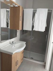 a bathroom with a sink and a shower at casa nonno luigi in Montalbano