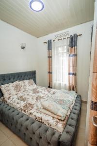 Ένα ή περισσότερα κρεβάτια σε δωμάτιο στο Casa Kigali