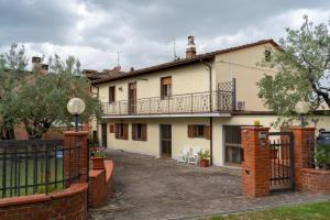 a large white house with a balcony on top of it at La Teodolinda in Arezzo