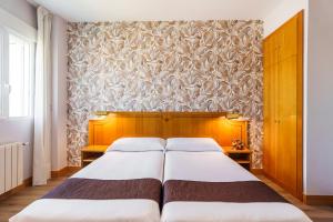 Ein Bett oder Betten in einem Zimmer der Unterkunft Hotel Rey Arturo Burgos