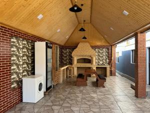 a patio with a fireplace in a brick building at Burj Sheki in Sheki