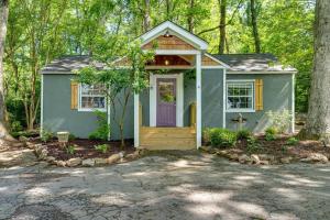 a tiny house in the woods with a purple door at 4- Sequatchie Cottage in Lookout Mountain