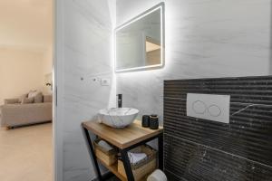 a bathroom with a bowl on a wooden table at Apartmani Sofija in Bibinje +44 photos