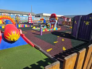 a playground with many different types of play equipment at Lbn Caravan in Kinmel Bay