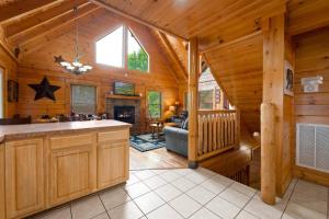 a kitchen and living room of a log cabin at Mountain Sunrise by Avada Properties in Sevierville