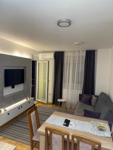 a living room with a couch and a table at Apartman Filip in Kruševac