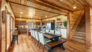 a kitchen and dining room with a table and chairs at Jericho Way- luxe retreat indoor pool theater room in Sevierville