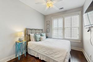 a bedroom with a bed and a ceiling fan at Price Street Place in Savannah