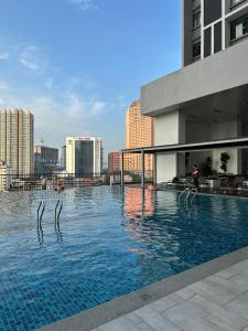 a swimming pool with swans in the water in a city at Chamber Luxury suites pwtc At KLCC in Kuala Lumpur