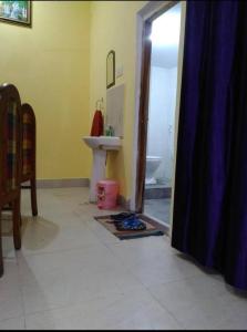 a bathroom with a sink and a toilet at Maa Ganga Homestay with free Pick and Drop facility in Varanasi