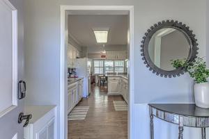 a hallway of a kitchen with a mirror and a table at Waterfront Family Home for 12 w Deck & Lake Views in Kingsland