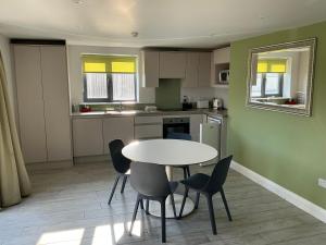 a kitchen with a table and chairs in a room at Arbutus Lodge in Killarney