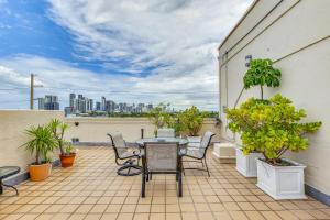 a patio with a table and chairs on a balcony at Wynwood Condo, Walk to Restaurants and Nightclubs! in Miami