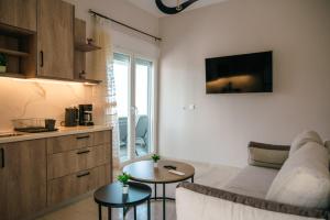 a living room with a couch and a table at Euphoria Loft in Karfas