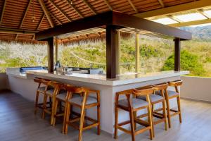 a kitchen with a counter with chairs around it at River Park Hotel in Puerto Vallarta