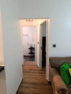 a living room with a couch and a hallway at Pleasant view in Tatu City +2 photos