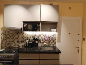a kitchen with white cabinets and a black counter top at Pleasant view in Tatu City