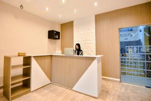 a woman sitting at a counter with a laptop at Solima Pyramids View in Cairo