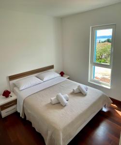 a bedroom with a large bed with two towels on it at Apartment on the beach Mare in Makarska
