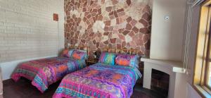 a room with two beds and a fireplace at Sandy Shores Cabaña 8B in La Paz