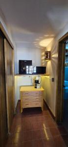 a kitchen with a yellow table in a room at Sandy Shores Cabaña 8B in La Paz