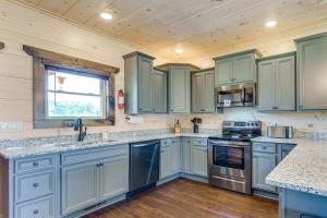 a kitchen with blue cabinets and a window at Misty Mountain Stop by Avada Properties in Pigeon Forge
