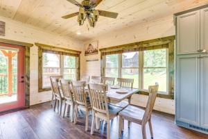a dining room with a table and chairs at Misty Mountain Stop by Avada Properties in Pigeon Forge