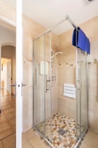 a shower with a glass door in a bathroom at Lime Tree Cottage Foxford County Mayo in Mayo