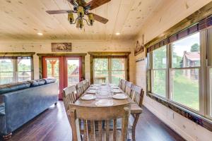 a dining room with a table and a ceiling fan at Misty Mountain Stop by Avada Properties in Pigeon Forge +33 photos