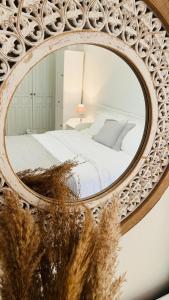 a mirror reflecting a bed in a bedroom at Villaggio View in Kariá