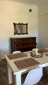a table with two chairs and a dresser with a mirror at Villaggio View in Kariá +5 photos