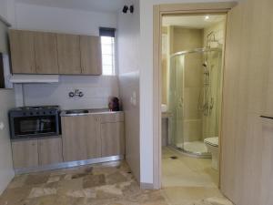 a bathroom with a shower and a sink and a toilet at Mare Vento in Kiveri +13 photos
