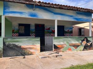 a building with a painting on the side of it at Canto da Sereia - Casa in Soure