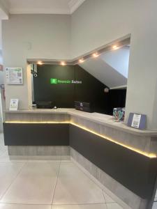 a lobby with a reception counter in a building at Rezende Suítes in Balneário Camboriú