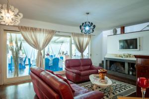 a living room with a couch and a table at ANTICA DIMORA STORICA VILLA DI l ABBIU RELAIS in Sorso